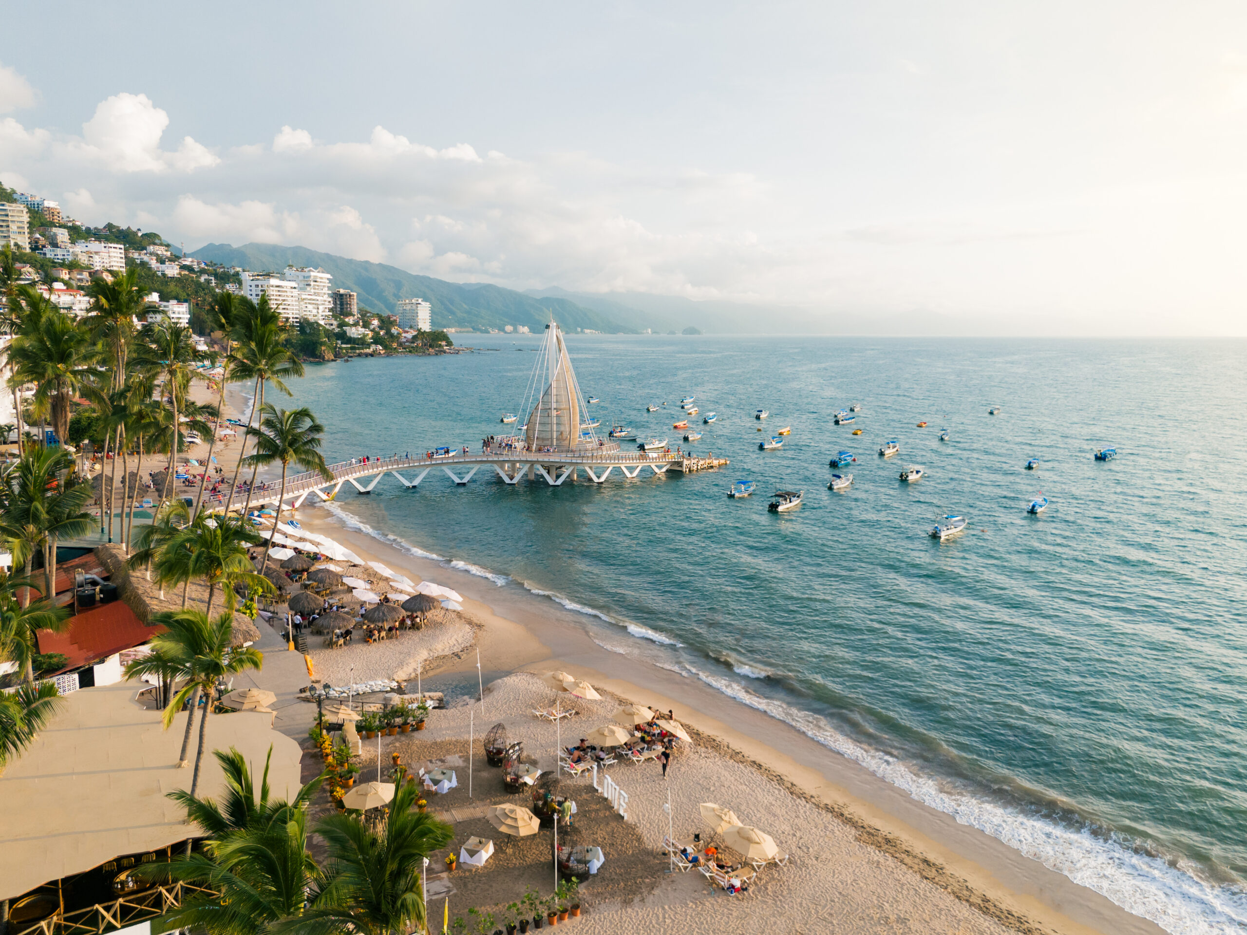 Sunset at Los Muertos Beach, Pier surrounded by Water Taxis. Jalisco, Mexico